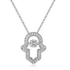 Silver-tone open hamsa necklace close-up with clear CZ stones framing the open hand and center stone
