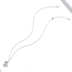 Full-length platinum-plated sterling silver necklace laid on white, showing the fine cable chain and clasp