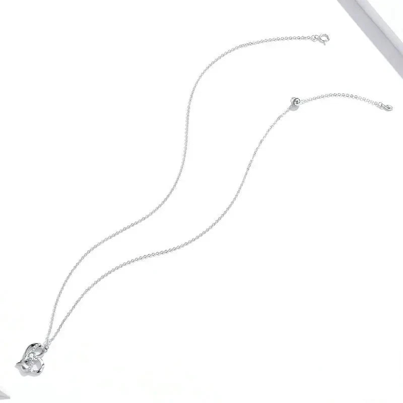 Full-length platinum-plated sterling silver necklace laid on white, showing the fine cable chain and clasp