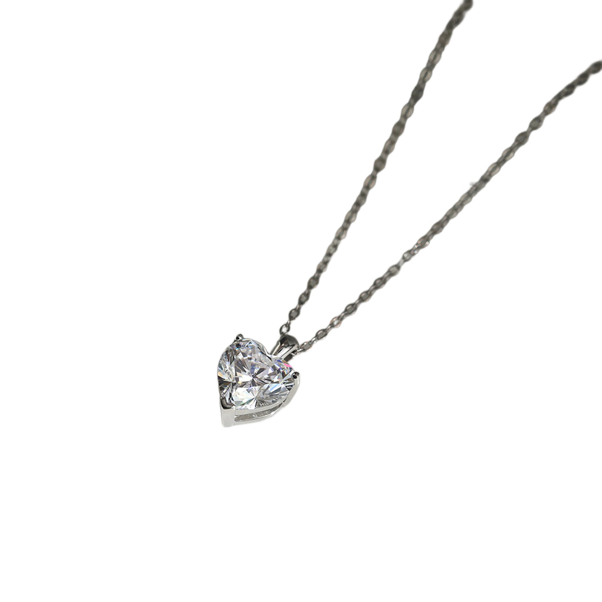 Silver-tone heart necklace with a clear faceted stone on a white background