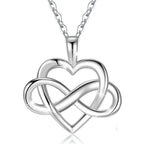 Silver open heart and woven infinity pendant suspended from a fine linked chain on white