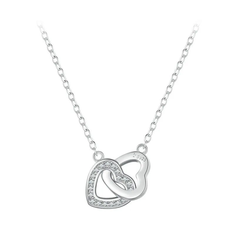 Silver-tone linked heart necklace with clear CZ stones and an S925 marking on white