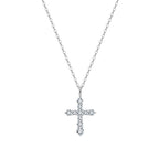 Silver-tone cross necklace with round moissanite stones on a white background