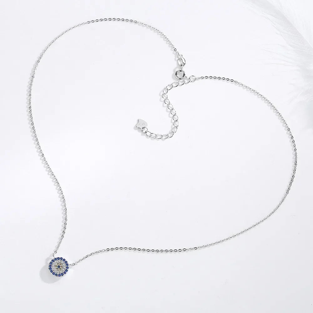 Silver-tone flower evil eye necklace laid out with a fine chain, clasp, and extender