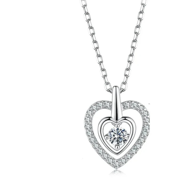 Front view of the silver nested heart necklace with stone-lined outer heart and prong-set center moissanite