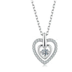 Front view of the silver nested heart necklace with stone-lined outer heart and prong-set center moissanite