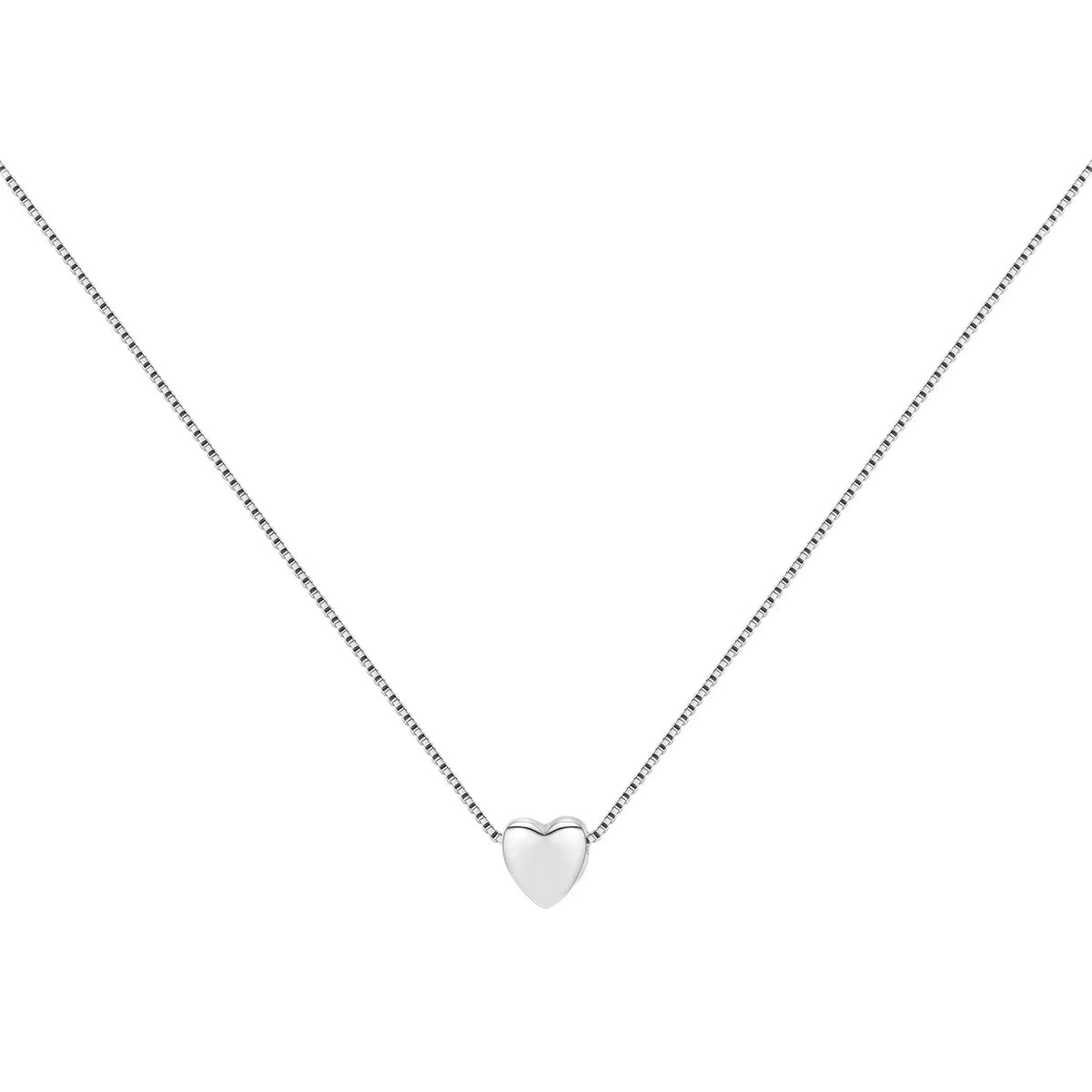 Small silver heart necklace with polished raised outline and fine box-link chain on a white background