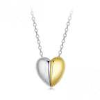 Front view of the polished split heart pendant with silver-colored and gold-plated halves