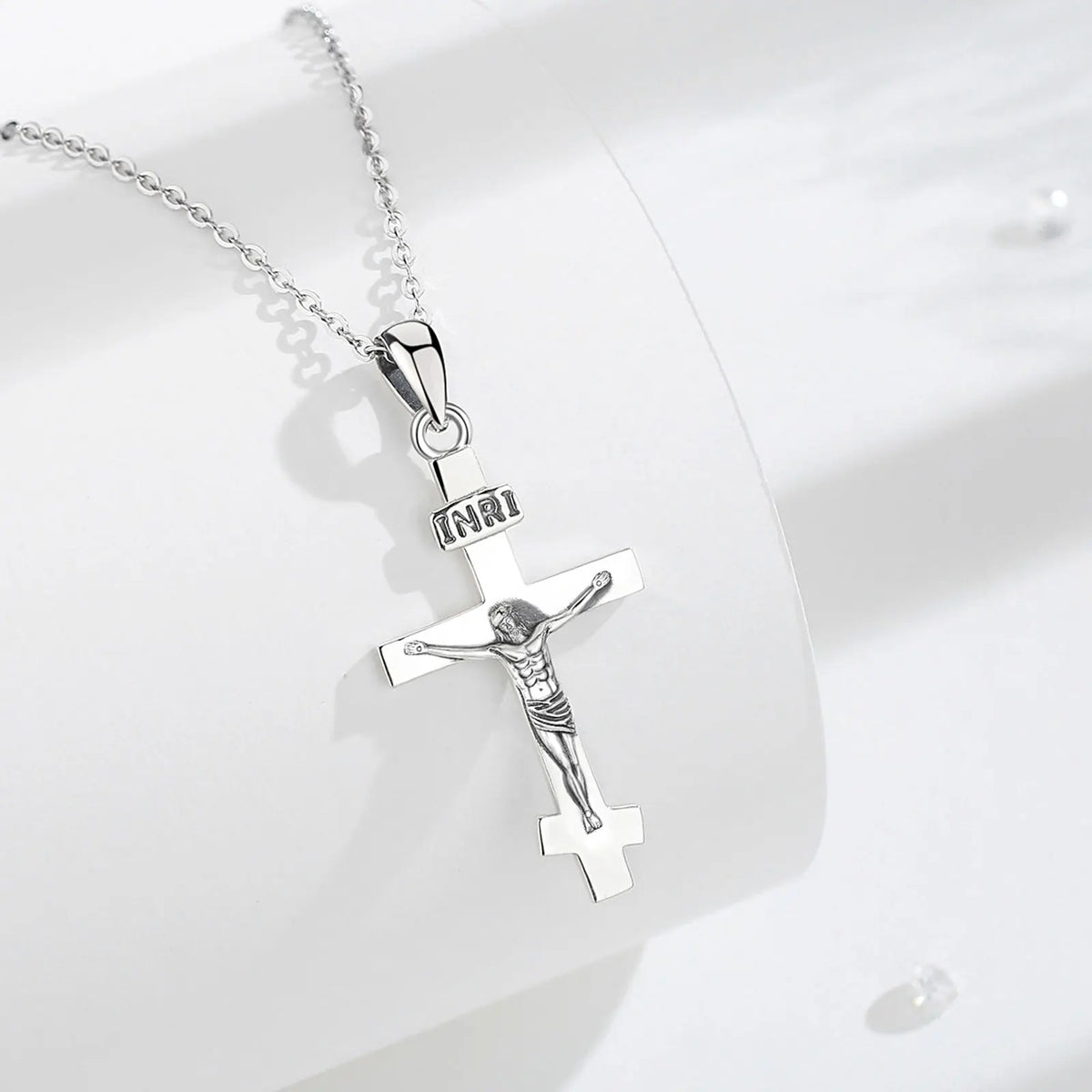 925 sterling silver crucifix necklace displayed on a white surface with a polished cross and INRI plaque