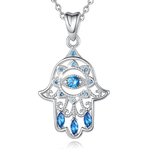 Sterling silver hamsa hand necklace on white with a faceted blue eye, petal details, and openwork scrolls