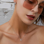 925 sterling silver open heart pendant worn on the neck, showing its off-center outline and CZ stone edge