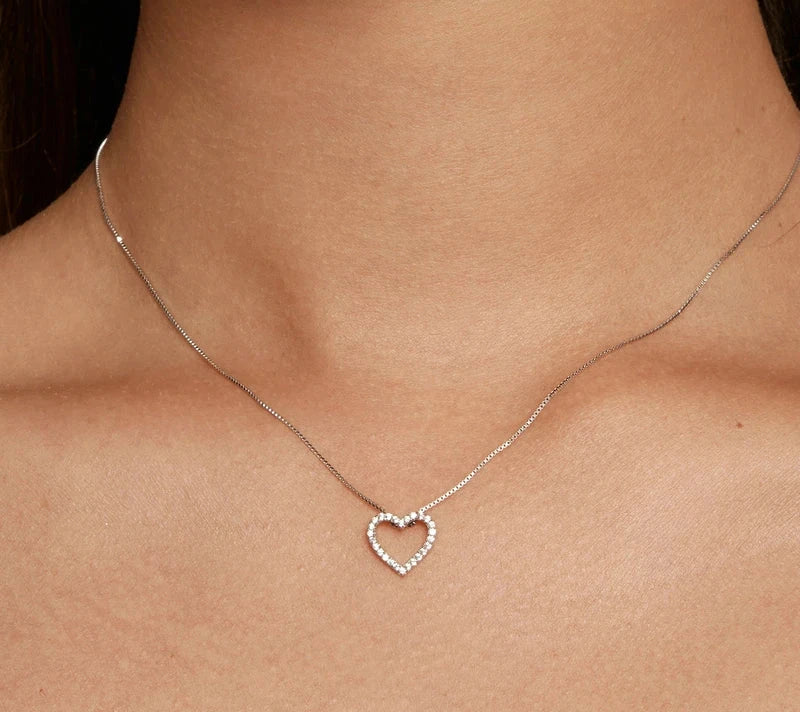 Close view of the 925 sterling silver open heart pendant worn on the neck