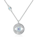Sunburst evil eye necklace in 925 sterling silver with blue CZ stones on a white background
