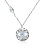 Sunburst evil eye necklace in 925 sterling silver with blue CZ stones on a white background