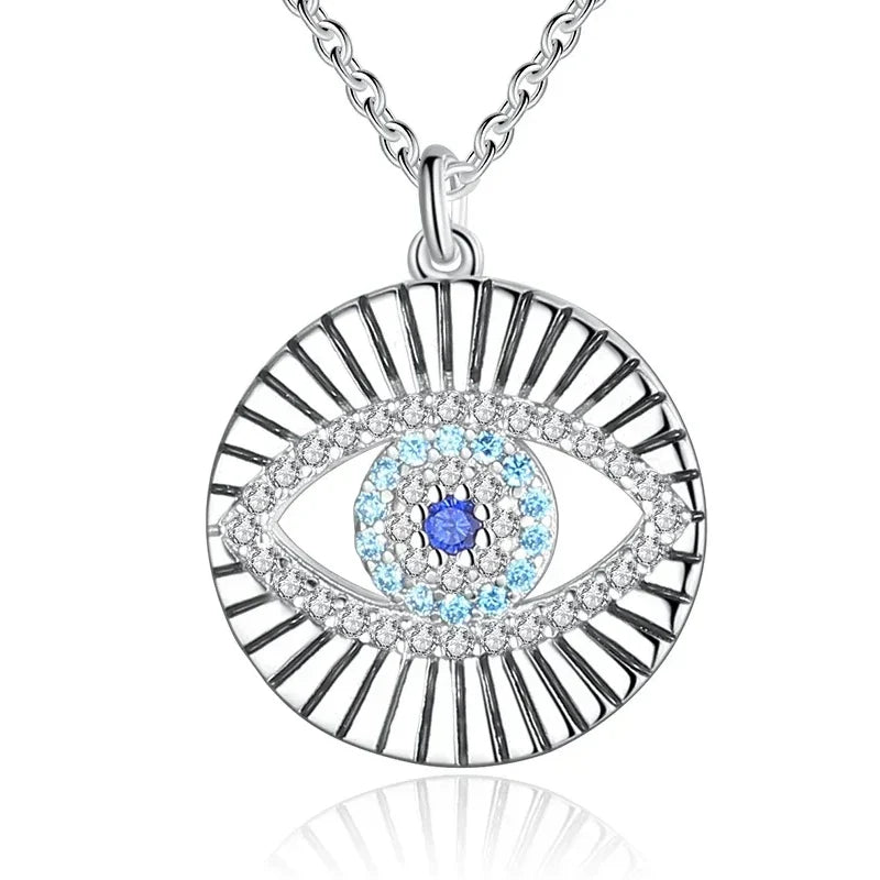 Close-up of the sunburst evil eye pendant with blue and clear CZ stones in 925 sterling silver