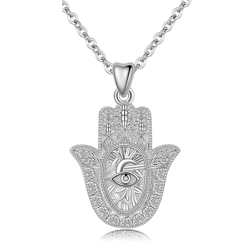 Textured 925 sterling silver hamsa hand necklace with raised eye and sunburst pendant on white