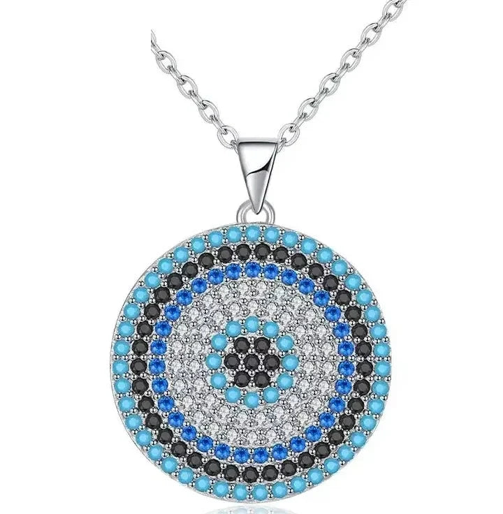 Turkish evil eye necklace in 925 sterling silver with clear CZ and blue, black, and turquoise-colored stone rings on white