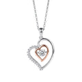 Two-tone heart pendant necklace on a white background with a clear cubic zirconia center stone