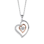 Two-tone heart pendant necklace on a white background with a clear cubic zirconia center stone