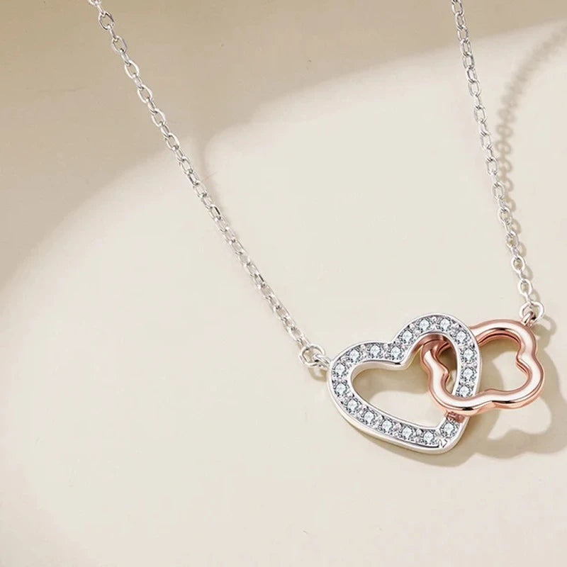 Flat lay of the two-tone heart pendant with a cubic zirconia-lined white gold-plated heart