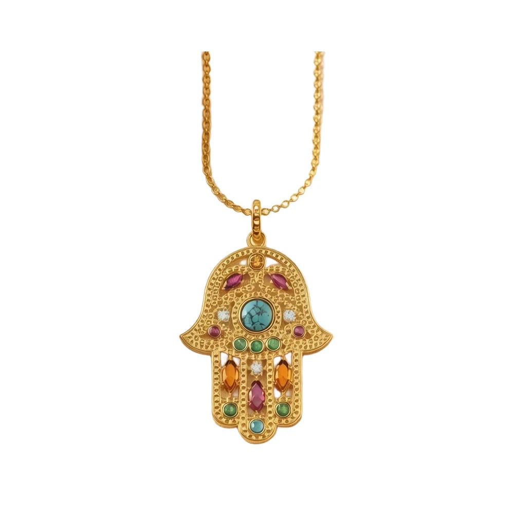 Vintage hamsa hand necklace with a turquoise-colored center and multicolored stones on white background